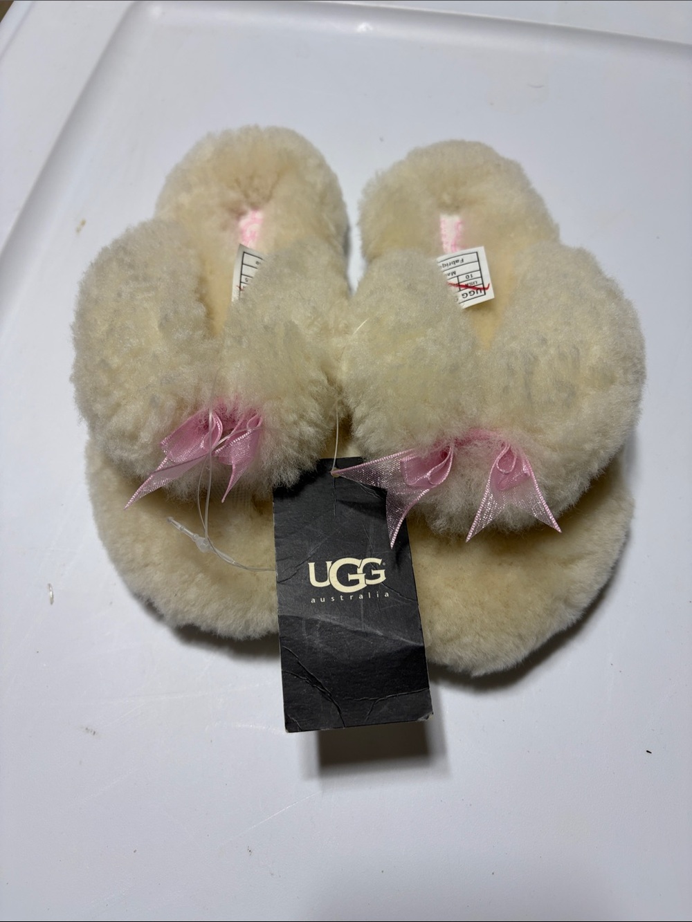 UGG Kids Cream Sheepskin Slippers with Pink Ribbon Accent
